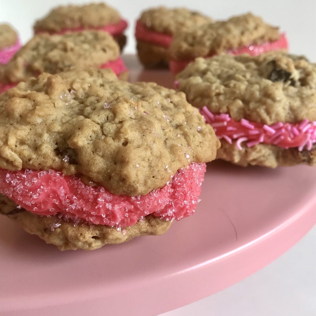 oatmeal raisin cookies with pink frosting and pink sanding sugar