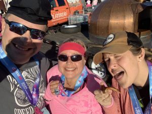 Chris, Gretchen, and Kyleigh after the Donna 5k at Neptune Beach, Florida - Kyleigh is eating pizza