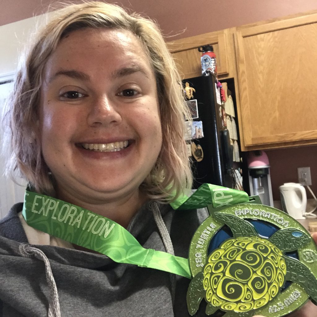 Gretchen with her Sea Turtle Exploration medal for completing 42.3 miles.